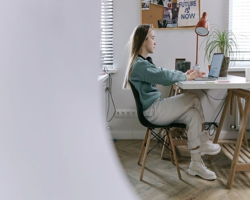 A person sitting comfortably at a modern home office setup