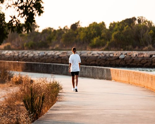 A person taking a relaxing walk in the afternoon